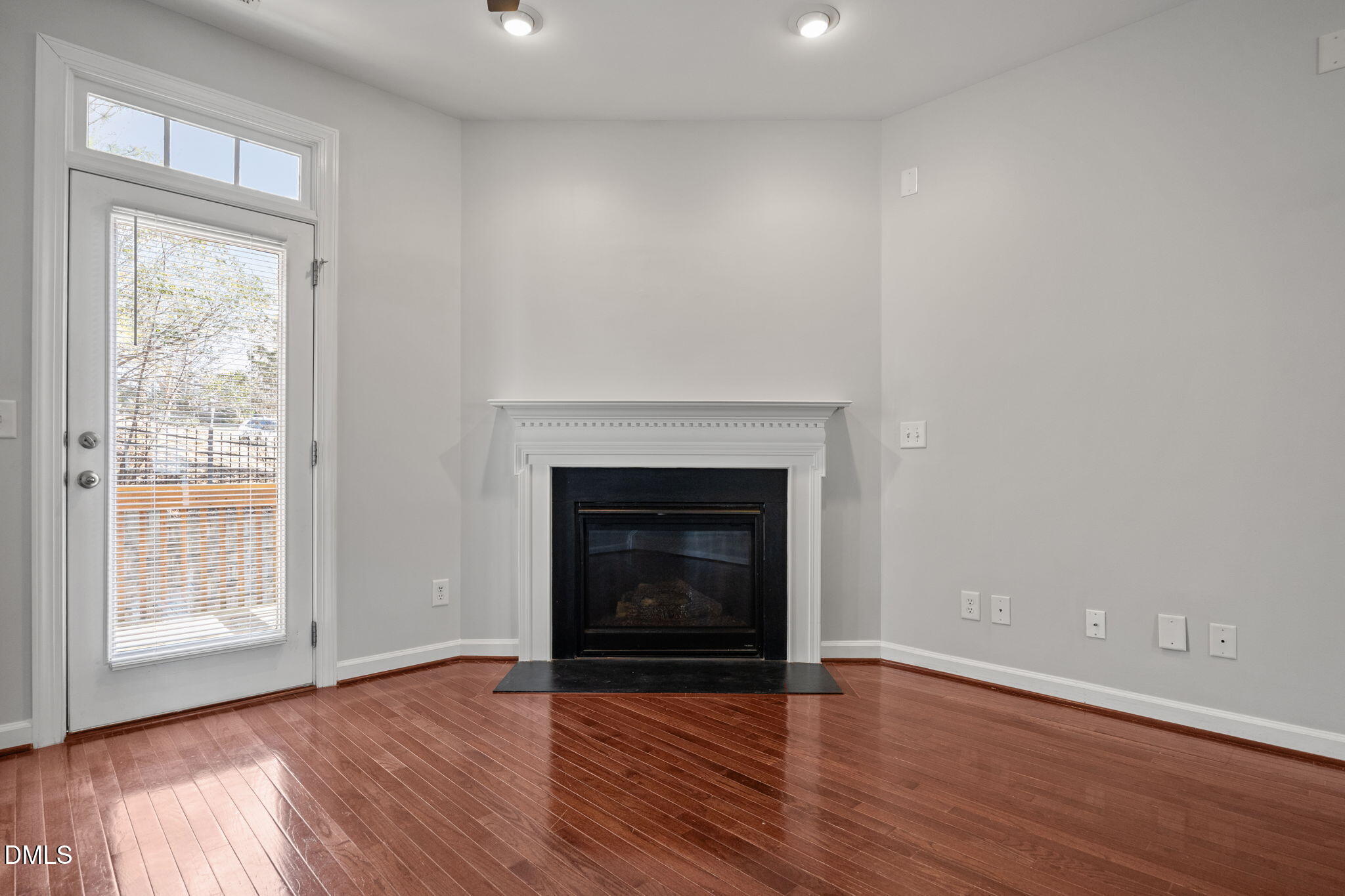 8006 Goldenrain Way Raleigh, NC 27612 - Photo 19 of 40 a living room with wooden floors and a fireplace