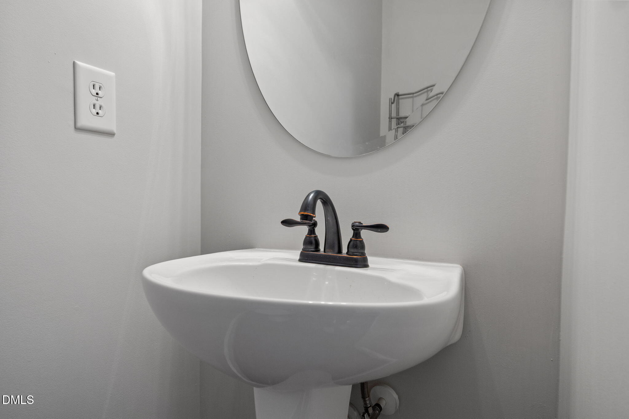 8006 Goldenrain Way Raleigh, NC 27612 - Photo 21 of 40 a bathroom with a sink and mirror