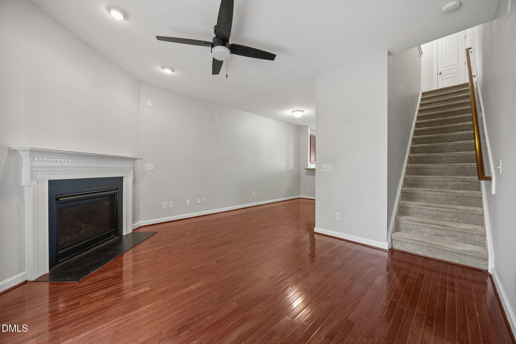 8006 Goldenrain Way Raleigh, NC 27612 - Photo 22 of 40 a view of an empty room with wooden floor fireplace and a window