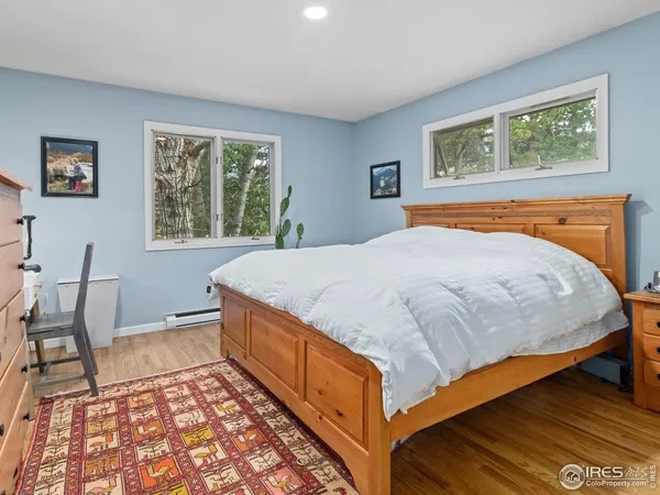 a bedroom with a bed a table and chair