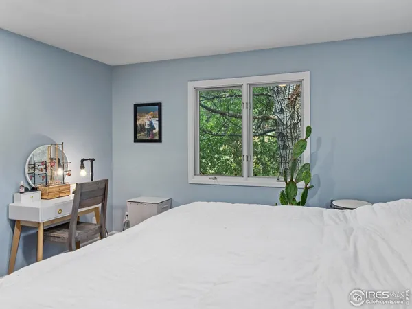 a bedroom with a bed table and window