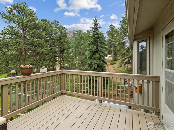 a view of balcony with wooden floor and fence