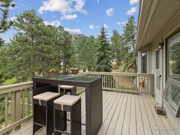 a view of a balcony with wooden floor and outdoor space