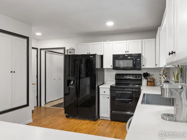 a kitchen with stainless steel appliances kitchen island granite countertop a refrigerator and a stove top oven