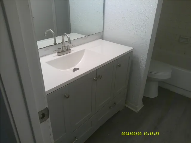 a bathroom with a sink and mirror