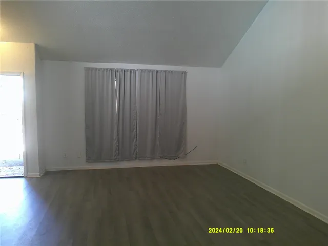 an empty room with wooden floor