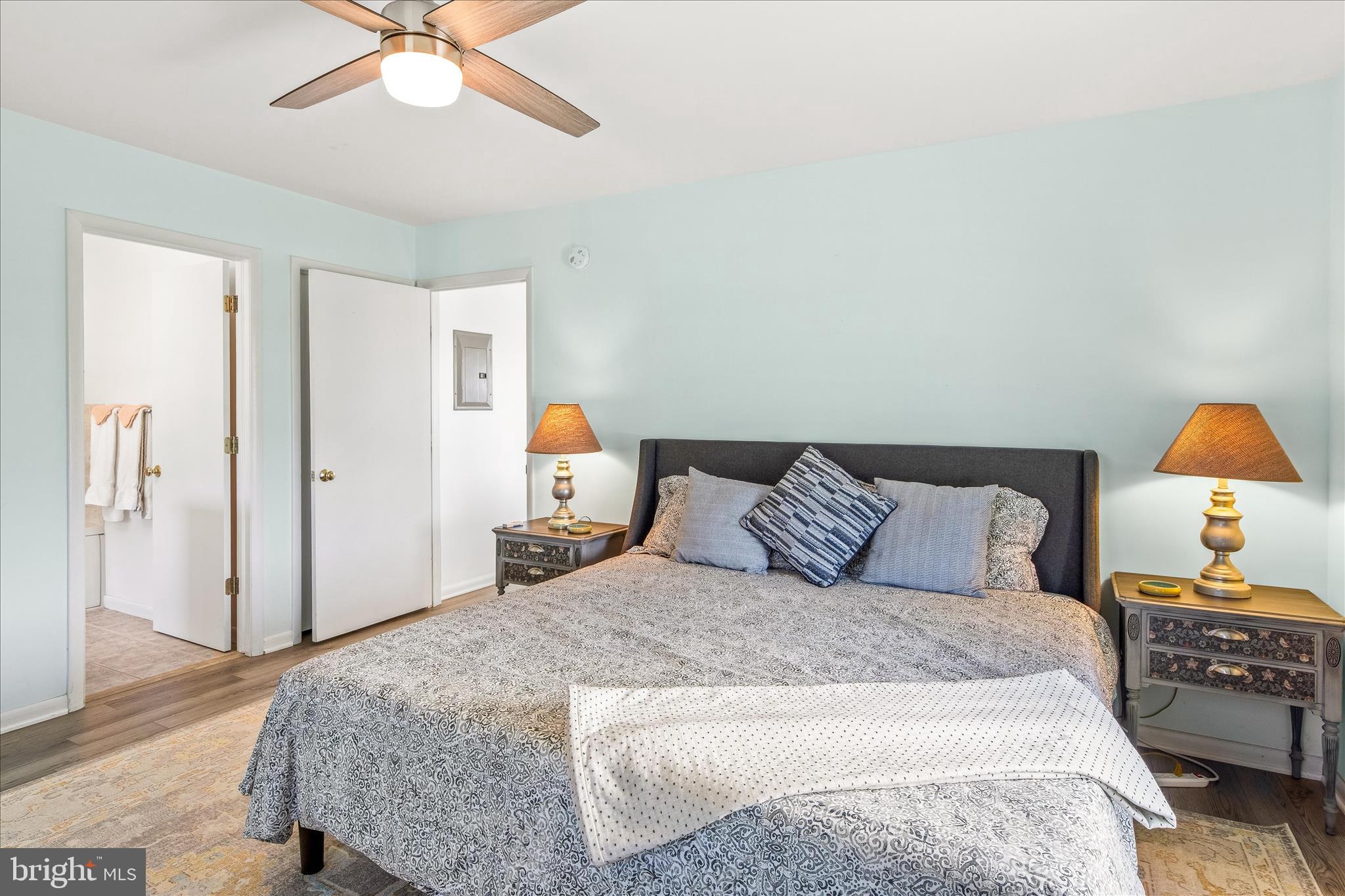 21406 Dogwood Cove Road Tilghman, MD 21671 - Photo 40 of 68 a bedroom with a bed and wooden floor