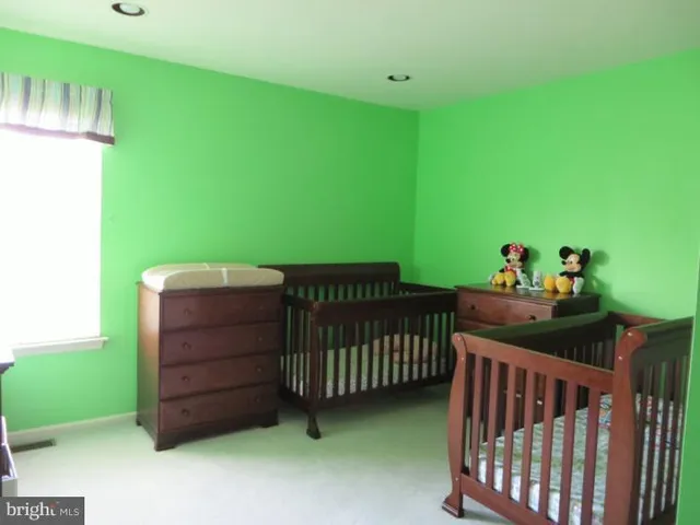 a view of a room with a baby crib