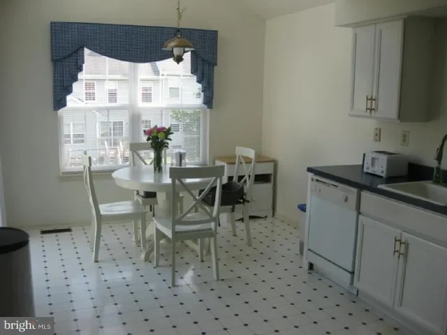 a dining room with furniture and a chandelier