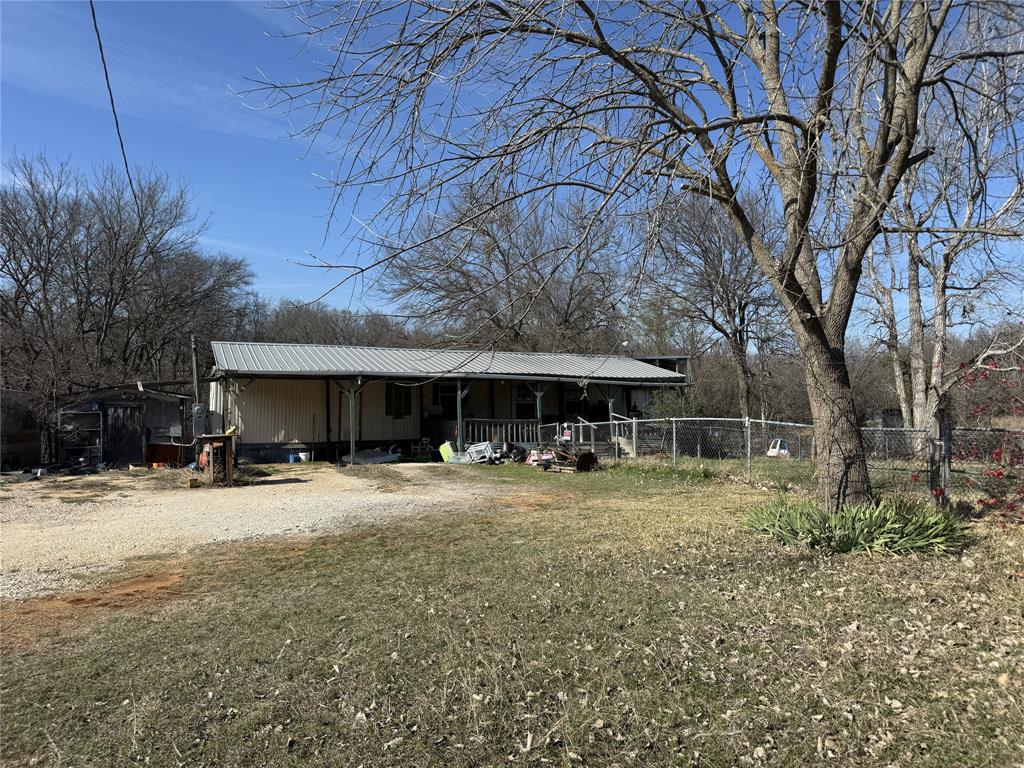 1161 Davis Court Rio Vista, TX 76093 - Photo 2 of 6 View of front of house with a porch, a metal roof, and driveway