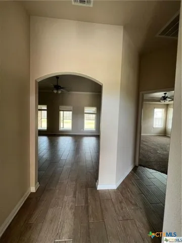 a view of a hallway with wooden floor