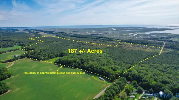 an aerial view of a houses with a yard