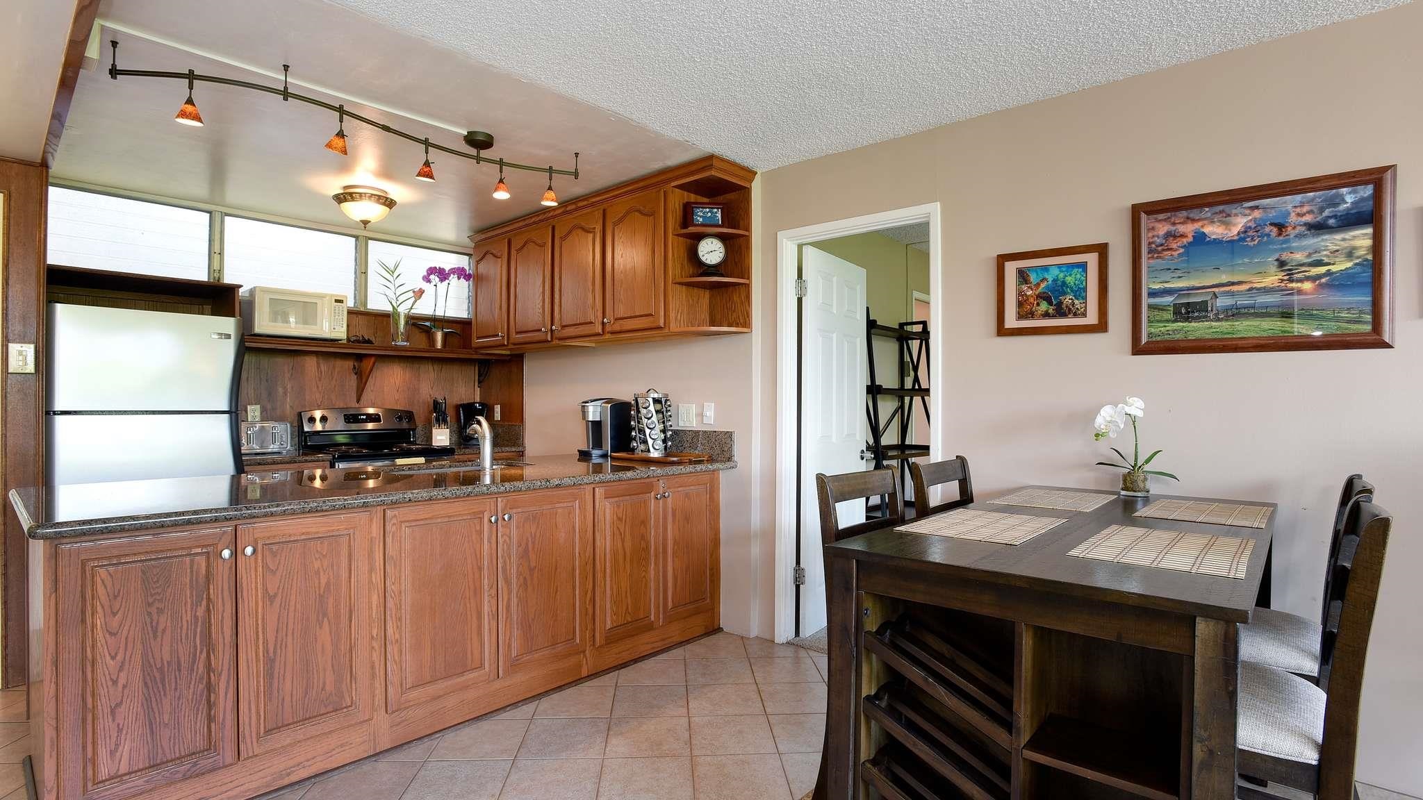 2619 South Kihei Road, Unit 309A Kihei, HI 96753 - Photo 11 of 41 a kitchen with stainless steel appliances granite countertop a stove and cabinets