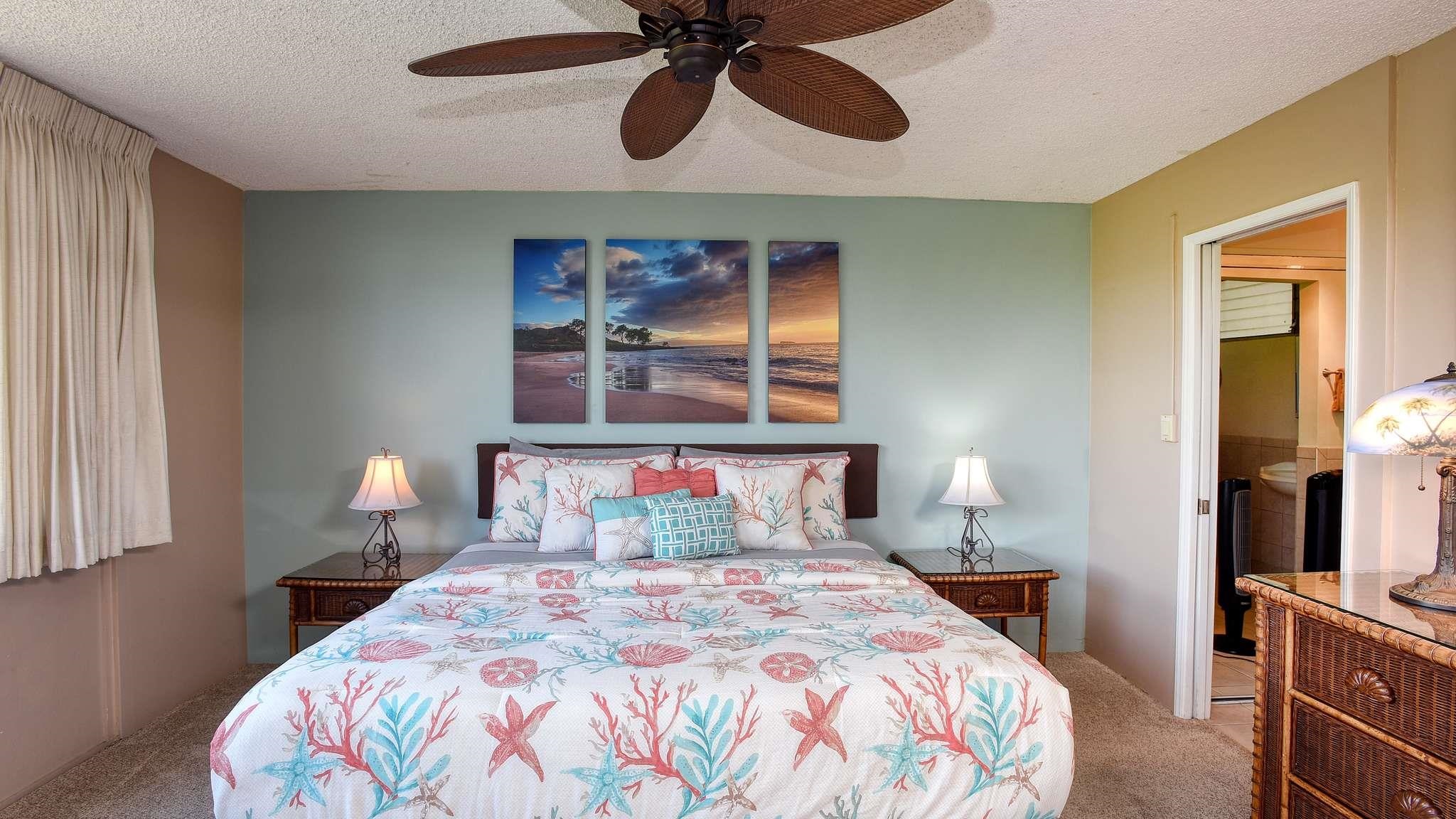2619 South Kihei Road, Unit 309A Kihei, HI 96753 - Photo 19 of 41 a bedroom with a bed and a chandelier