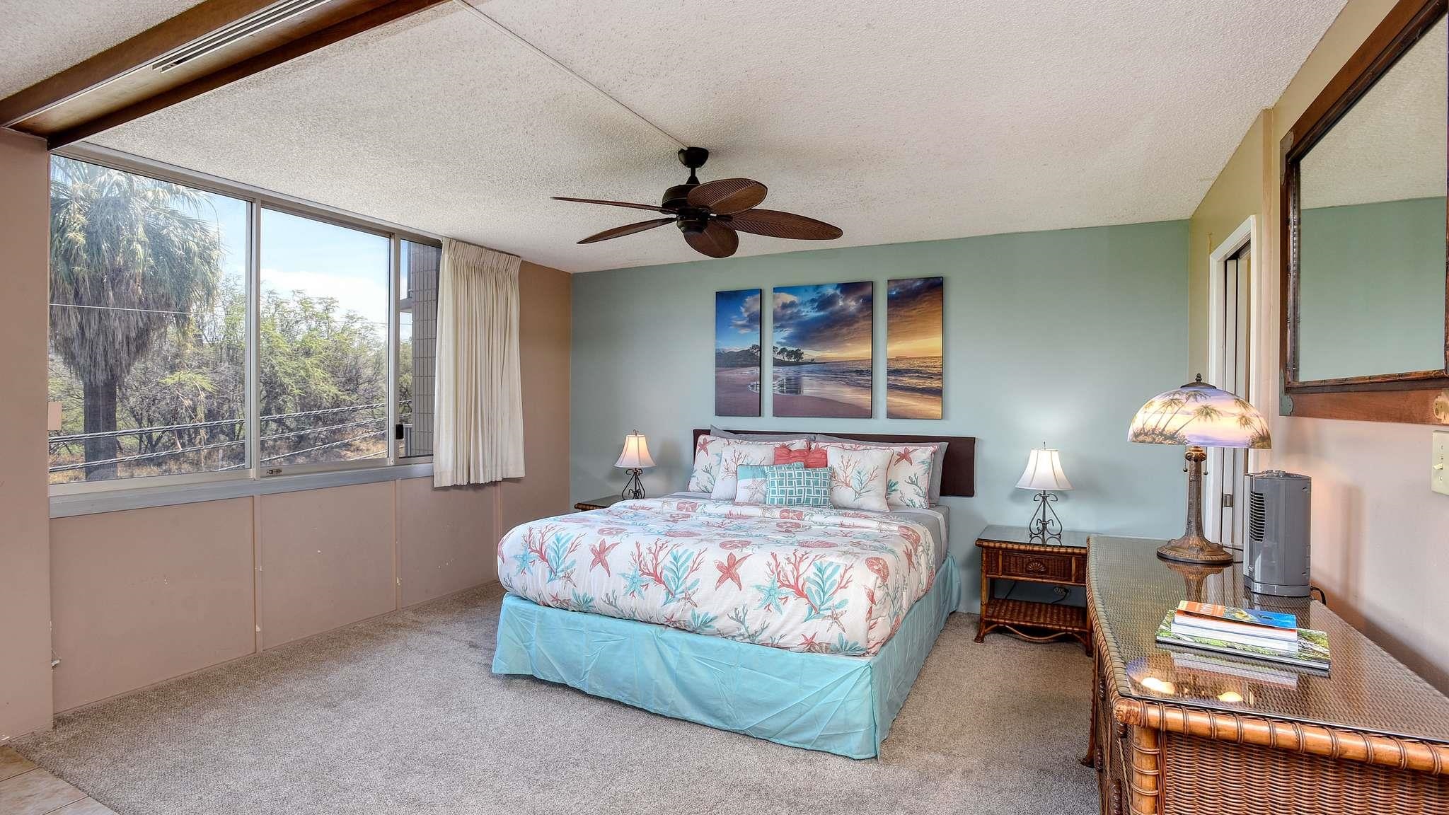 2619 South Kihei Road, Unit 309A Kihei, HI 96753 - Photo 7 of 41 a bedroom with a bed a chandelier and a window