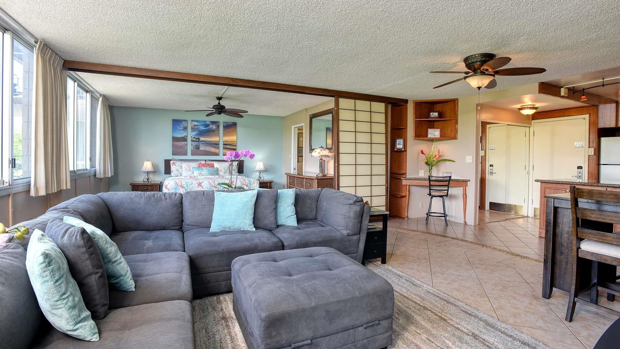 2619 South Kihei Road, Unit 309A Kihei, HI 96753 - Photo 8 of 41 a living room with furniture and a chandelier