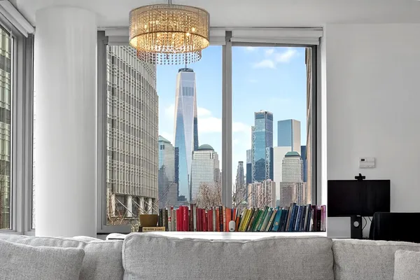 a living room with furniture and a chandelier