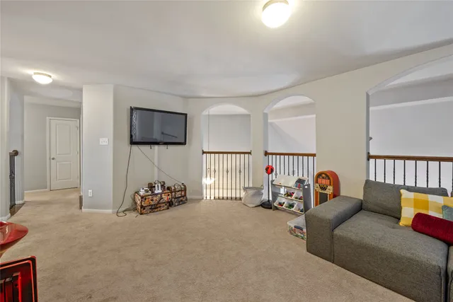 a living room with furniture a flat screen tv and a couch