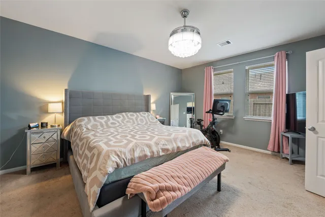 a bedroom with a bed and a chandelier