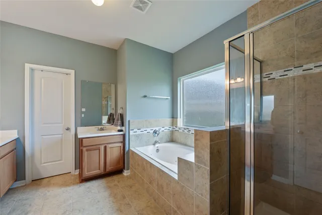 a bathroom with a bathtub and a sink