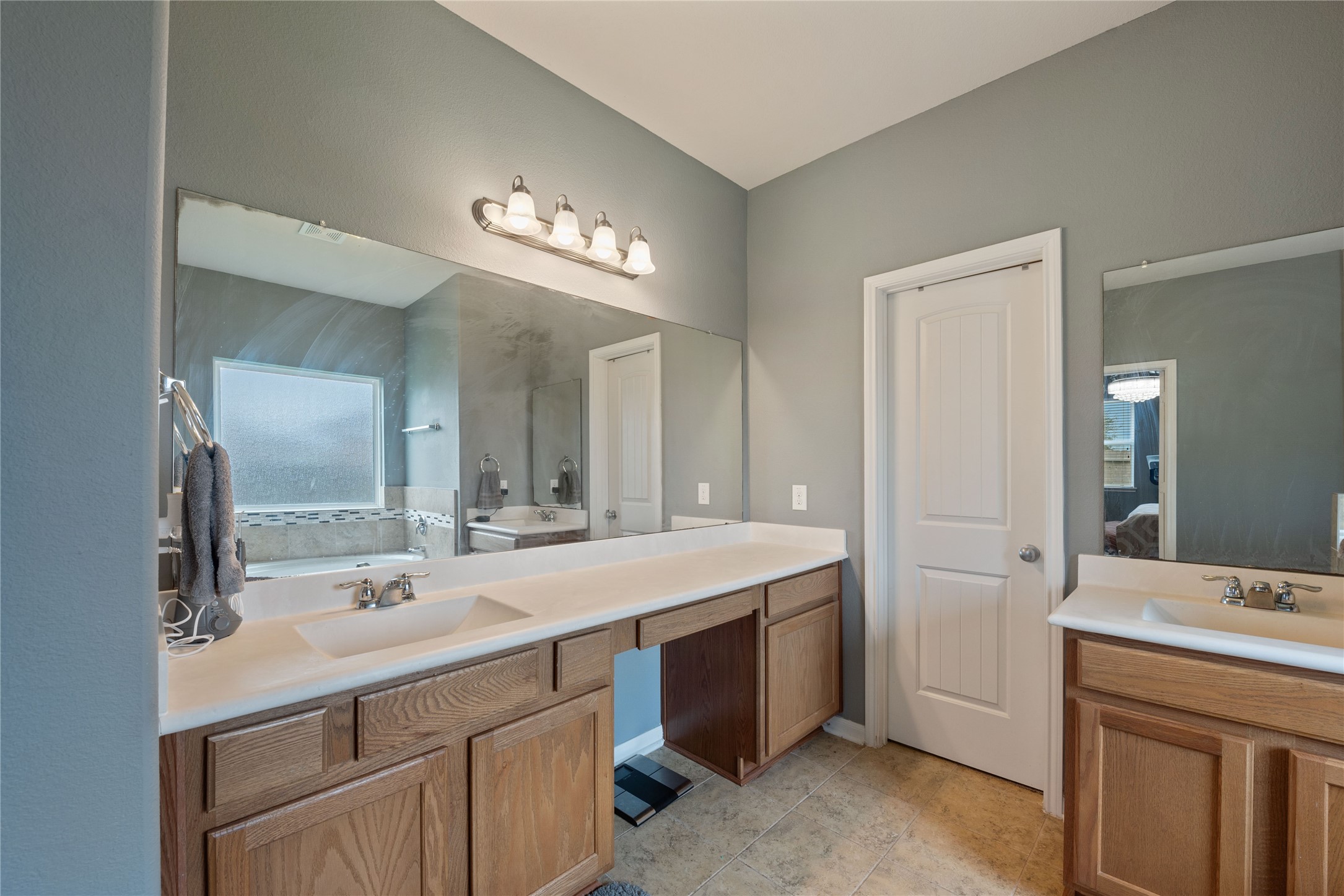 970 Jennifer Street Alvin, TX 77511 - Photo 20 of 27 a bathroom with a double vanity sink and a mirror
