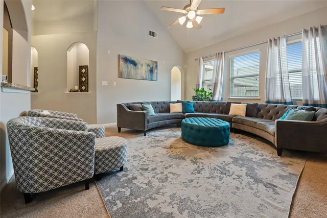 a living room with furniture and a large window