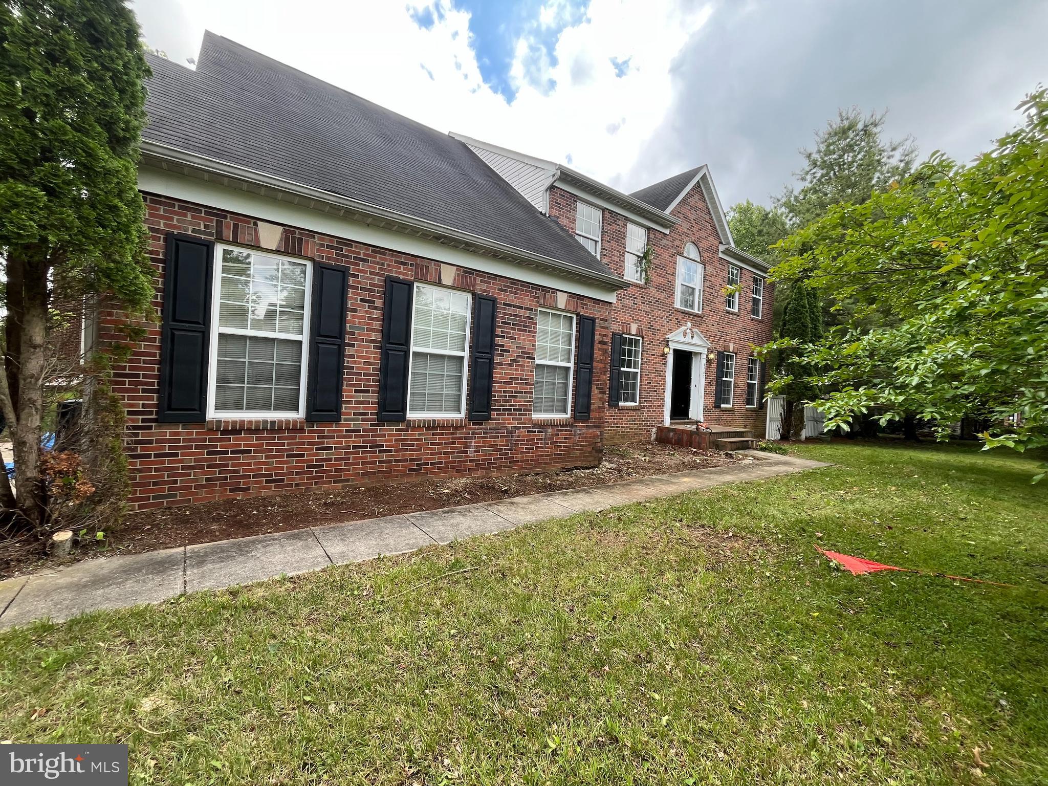 8207 Rison Drive Brandywine, MD 20613 - Photo 3 of 31 a front view of a house with a yard