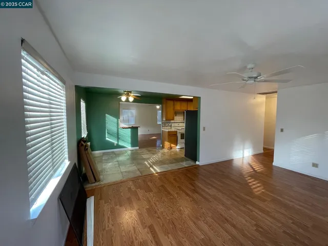 a view of a room with wooden floor and staircase