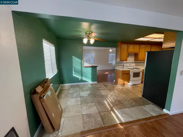 a view of kitchen with refrigerator stove and microwave