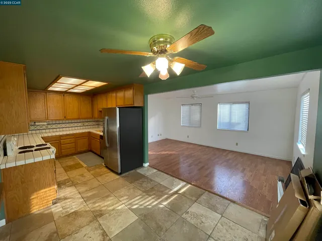 a kitchen with stainless steel appliances granite countertop a sink dishwasher and a refrigerator