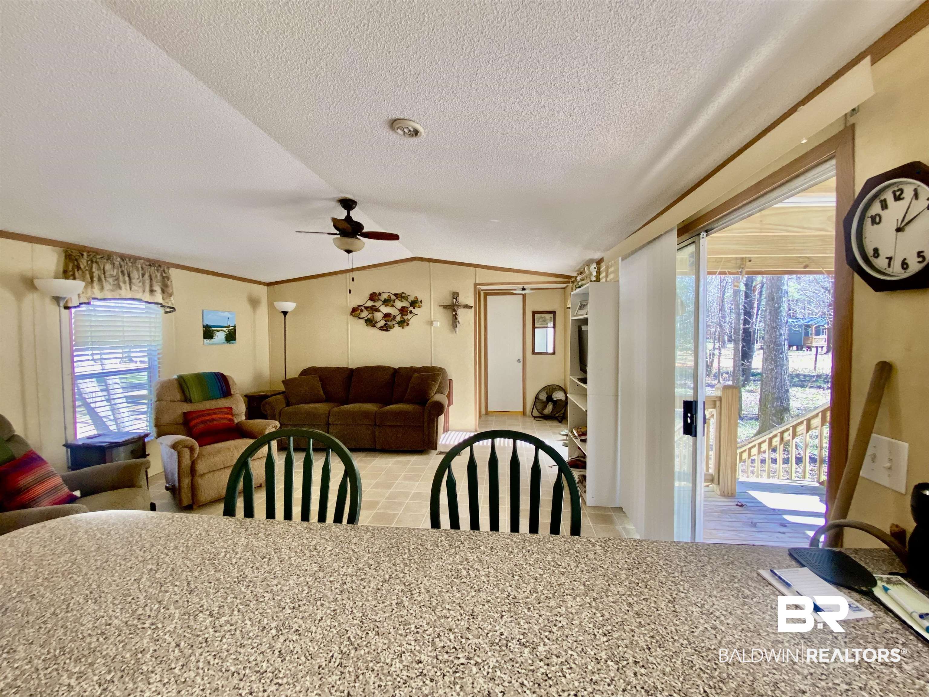 294 Eureka Way Uriah, AL 36480 - Photo 7 of 18 Dining area with vaulted ceiling, ceiling fan, a textured ceiling, and crown molding