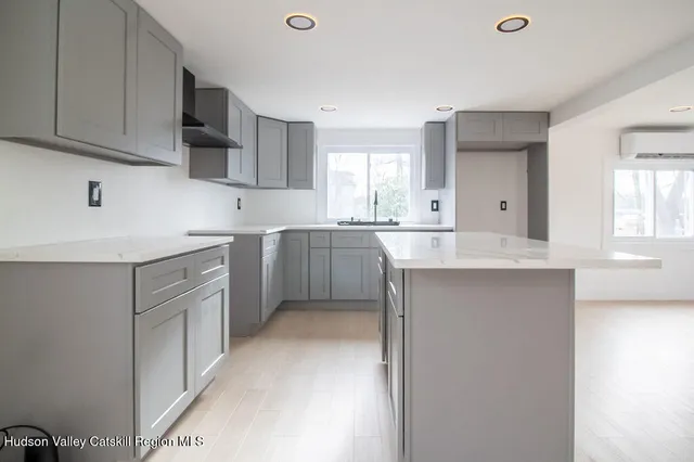 a kitchen with a sink cabinets appliances and a window