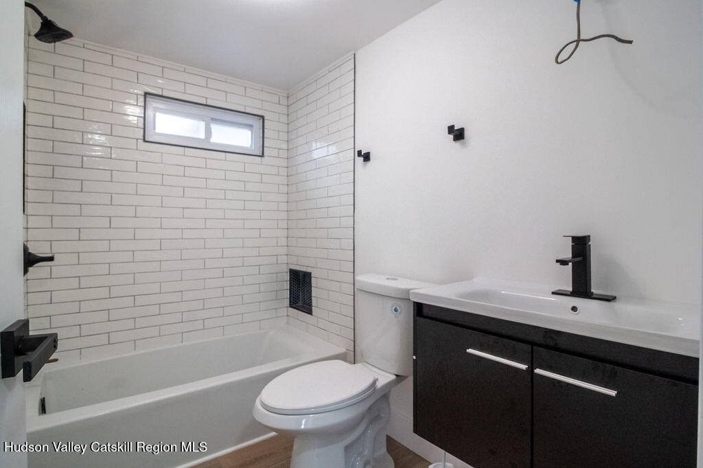 1732 Ulster Heights Road Ellenville, NY 12428 - Photo 26 of 40 a bathroom with a sink a toilet and shower