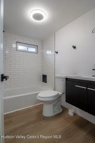 a bathroom with a toilet a sink and bathtub