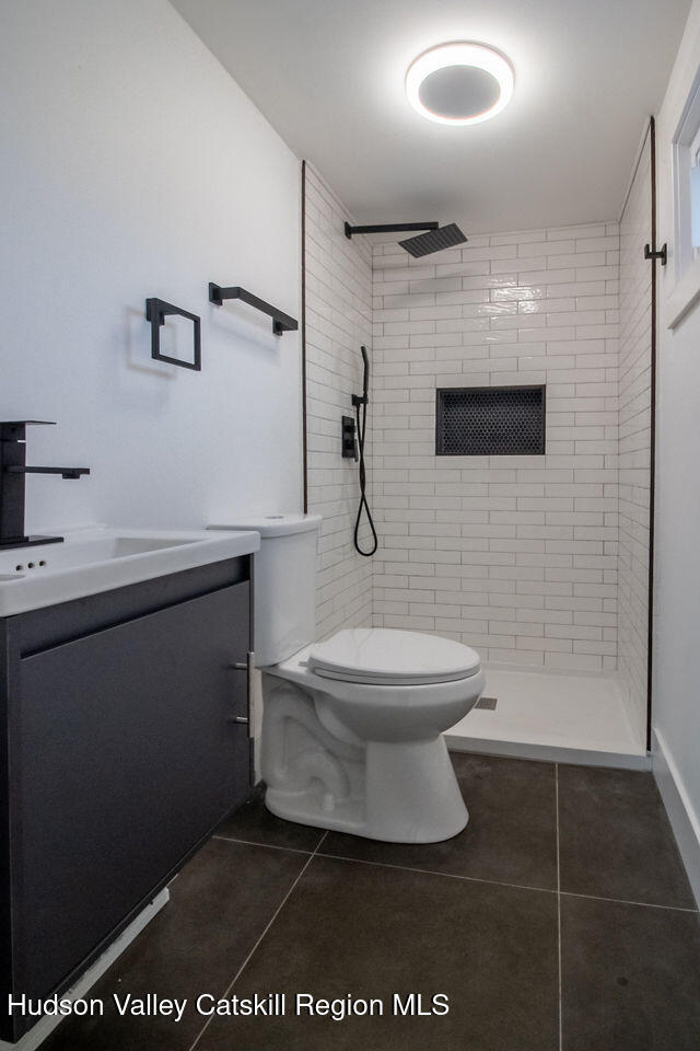 1732 Ulster Heights Road Ellenville, NY 12428 - Photo 34 of 40 a bathroom with a toilet a sink and mirror