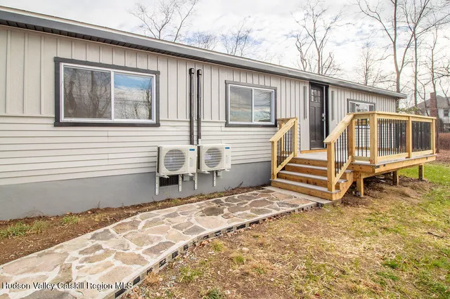 a backyard of a house with wooden floor and fence