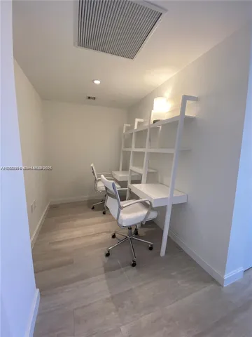 a work room with furniture and white walls