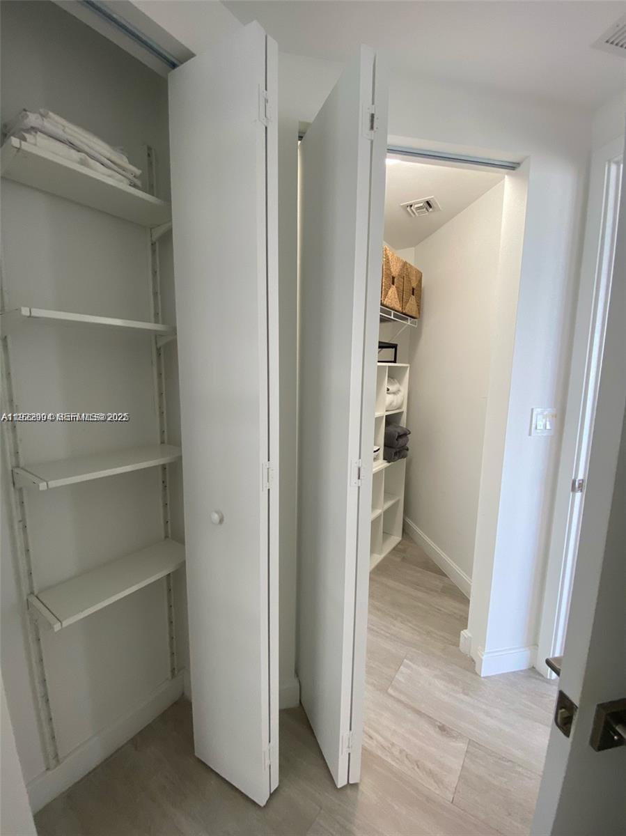 55 Southwest 9th Street, Unit 3001 Miami, FL 33130 - Photo 21 of 28 a view of walk in closet with empty racks