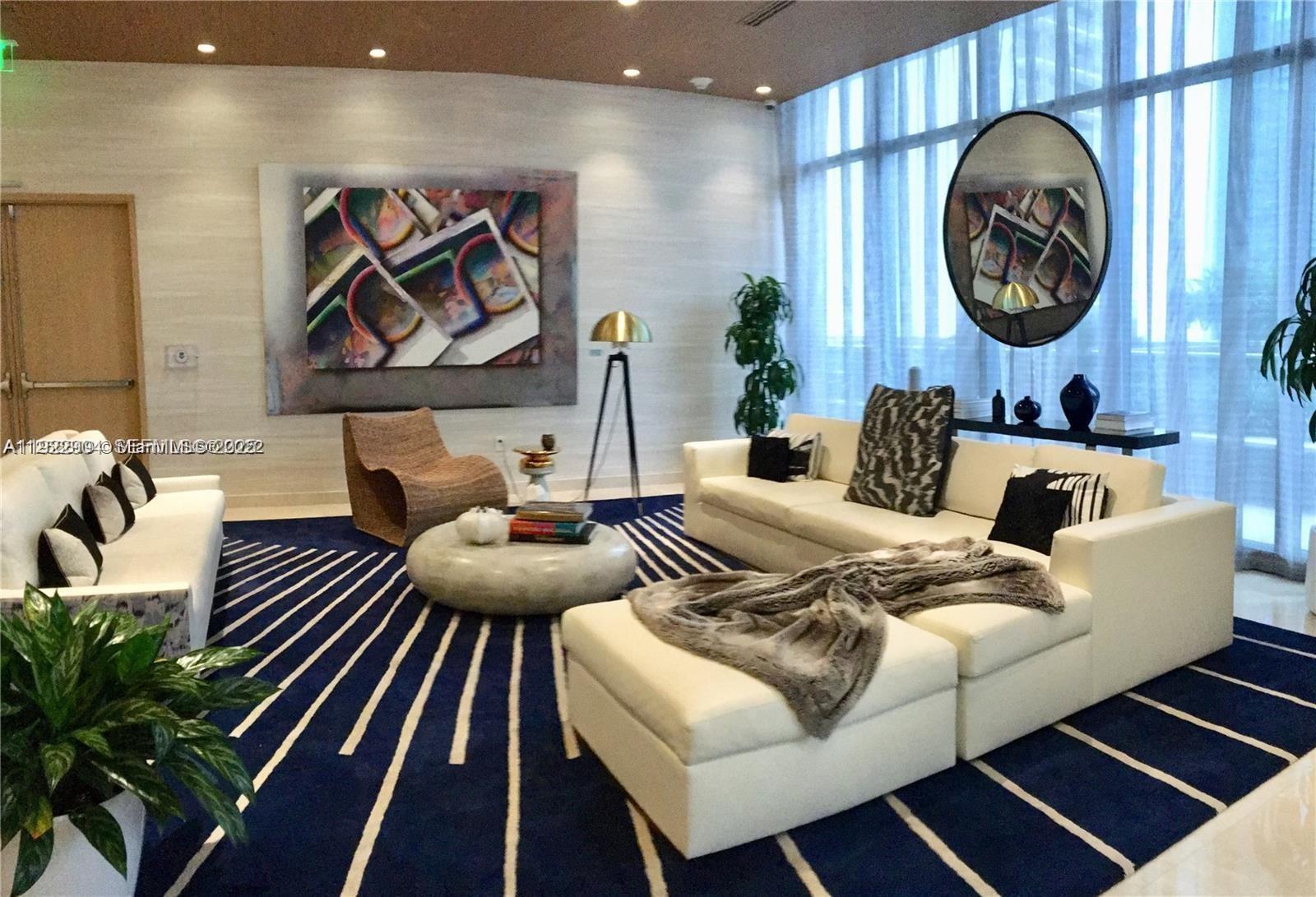 55 Southwest 9th Street, Unit 3001 Miami, FL 33130 - Photo 24 of 28 a living room with furniture and wall paintings