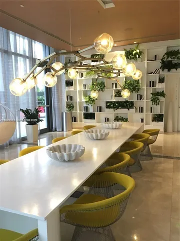 a room with pool table and chairs