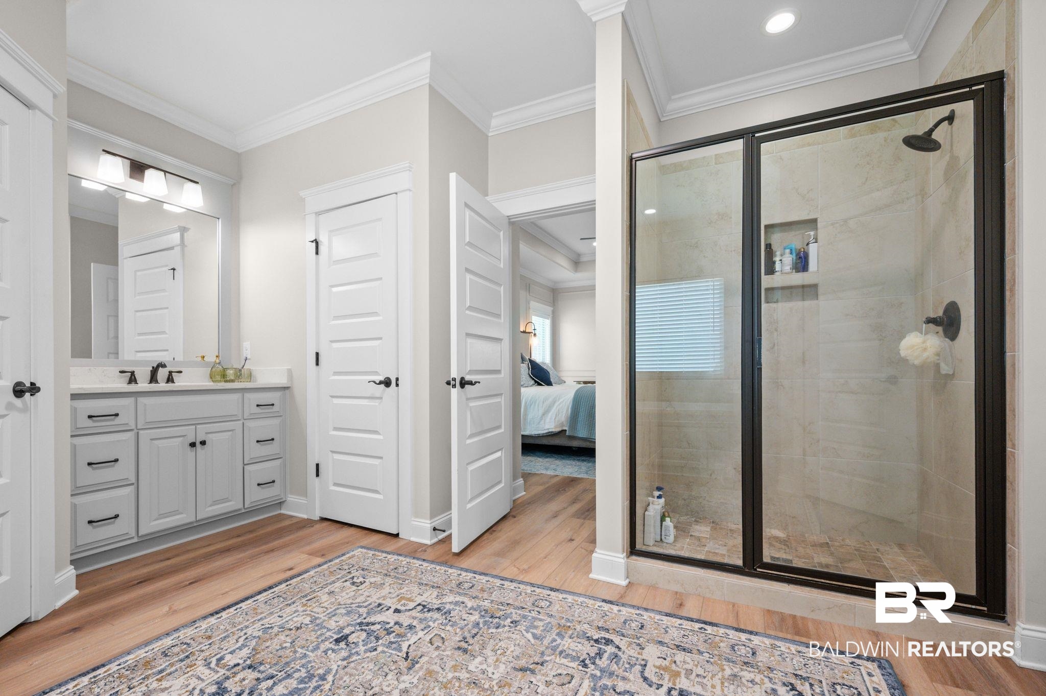 409 Fortune Drive Fairhope, AL 36532 - Photo 18 of 42 Spacious bathroom featuring a glass-enclosed shower with matte black fixtures and tiled walls