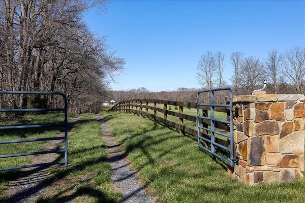 a view of a yard with wooden fence