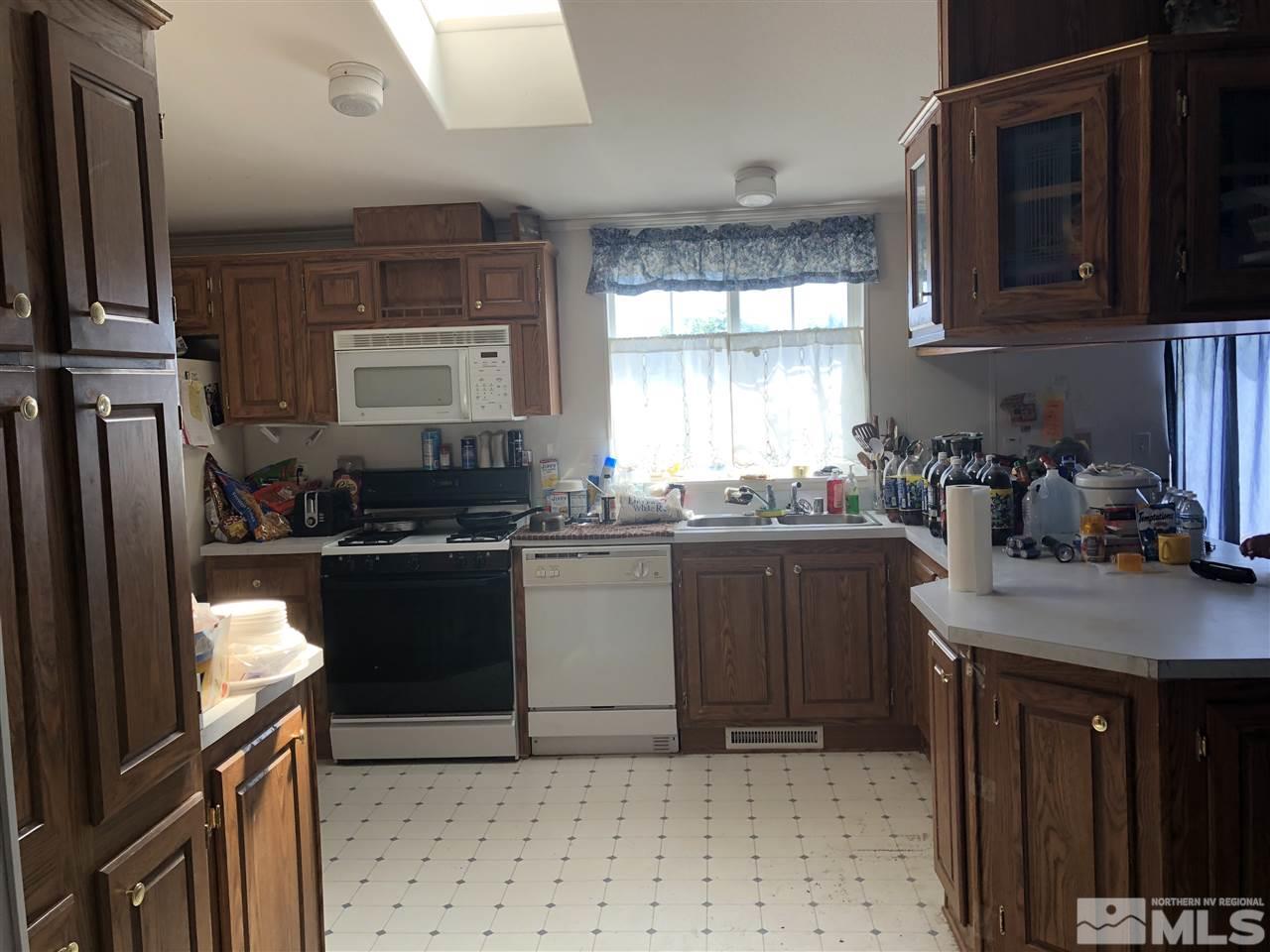 5118 Coggins Road Reno, NV 89506 - Photo 5 of 9 a kitchen with a refrigerator and a stove top oven