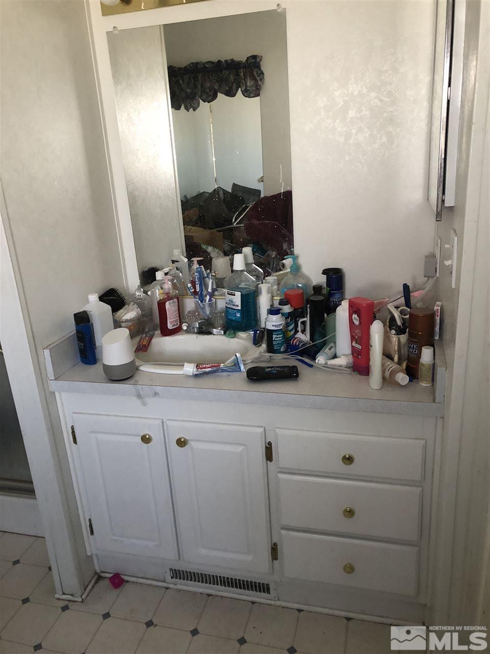 5118 Coggins Road Reno, NV 89506 - Photo 9 of 9 a bathroom with a sink and a mirror