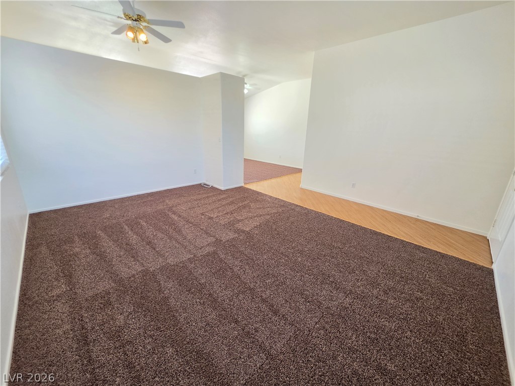 1154 Point Success Avenue Henderson, NV 89014 - Photo 10 of 26 A versatile living space combines plush carpeting with durable wood-look flooring.