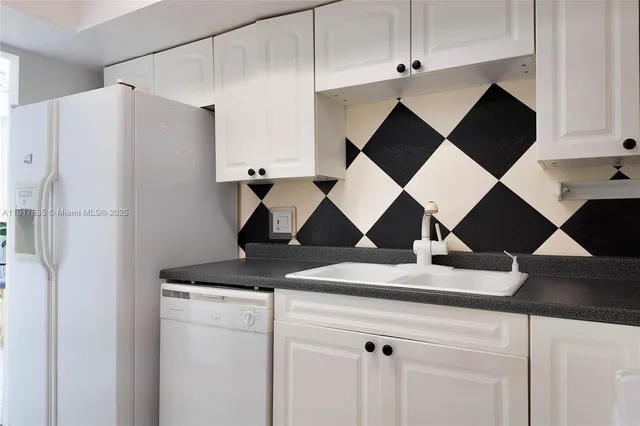 a close view of a refrigerator and a sink