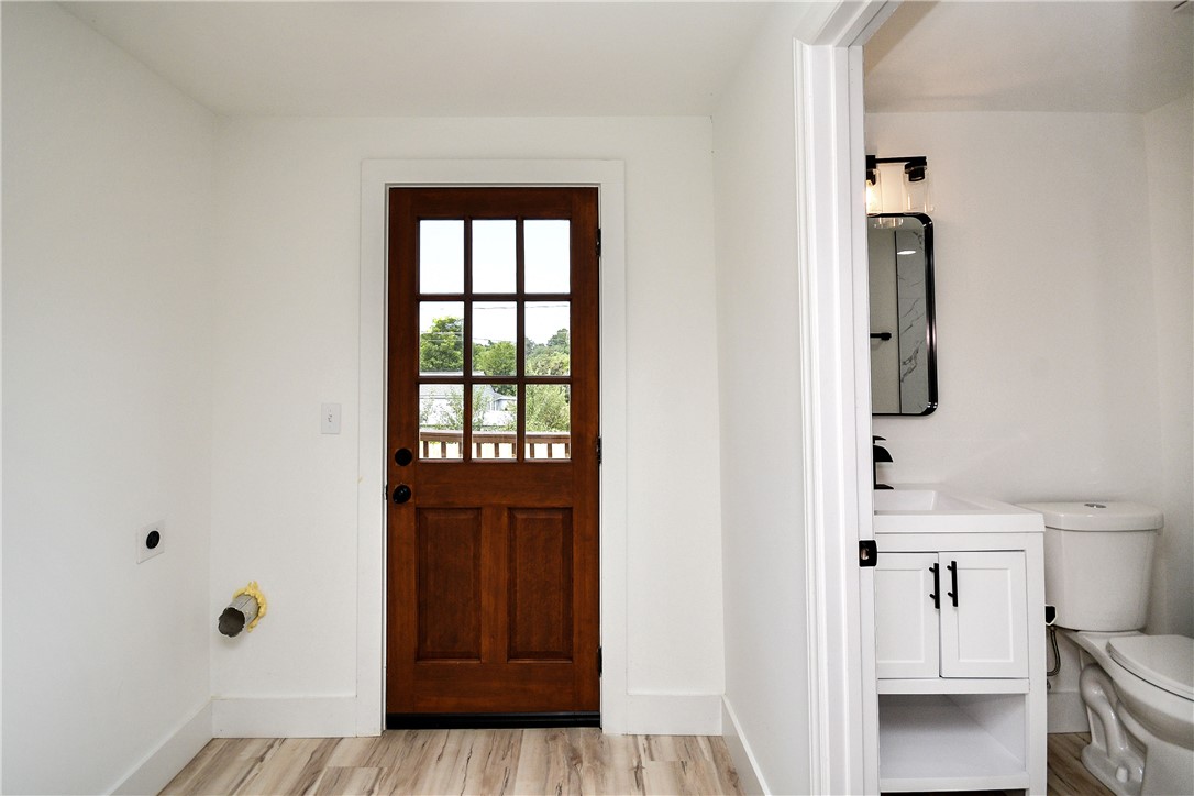 407 I Street Anderson, SC 29625 - Photo 19 of 43 A rich wooden door with windowpanes opens to a private balcony, complemented by light wood flooring.
