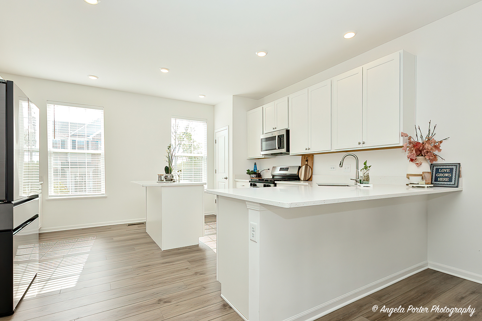 1004 Neubauer Circle Lindenhurst, IL 60046 - Photo 3 of 29 a kitchen with stainless steel appliances a sink stove and white cabinets with wooden floor