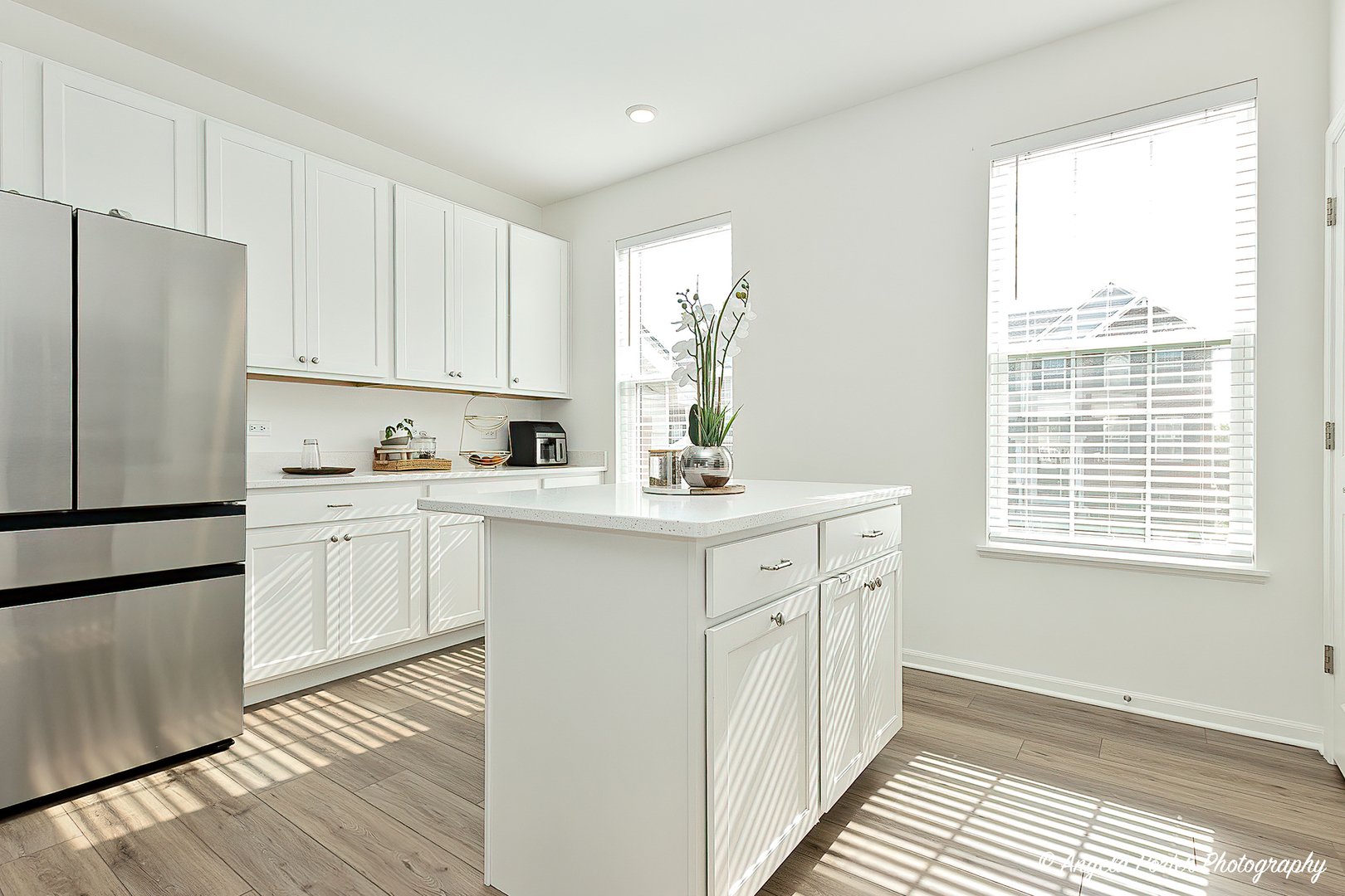 1004 Neubauer Circle Lindenhurst, IL 60046 - Photo 6 of 29 a kitchen with white cabinets and white appliances