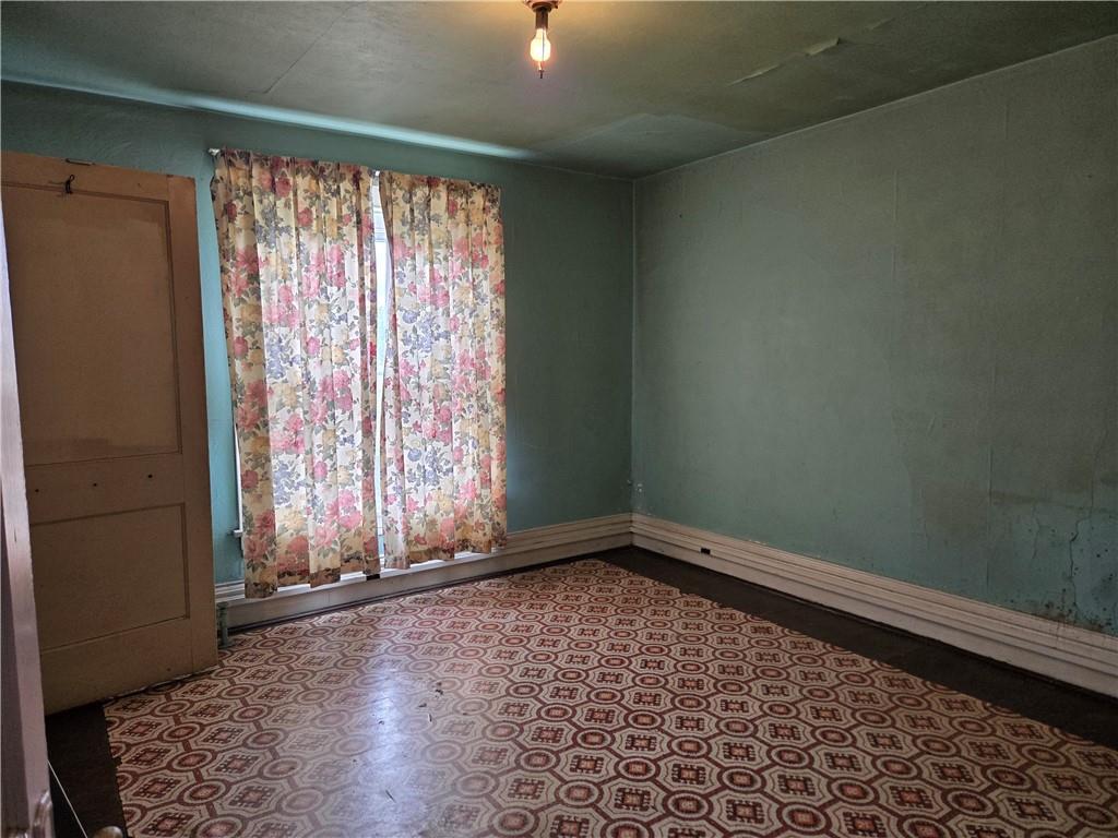 438 8th Street Donora, PA 15033 - Photo 18 of 26 an empty room with wooden floor and windows